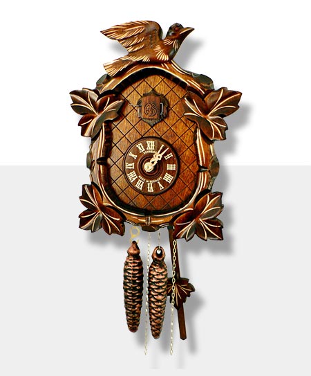 Carved cuckoo clock with bird motif in dark brown on a gray background.